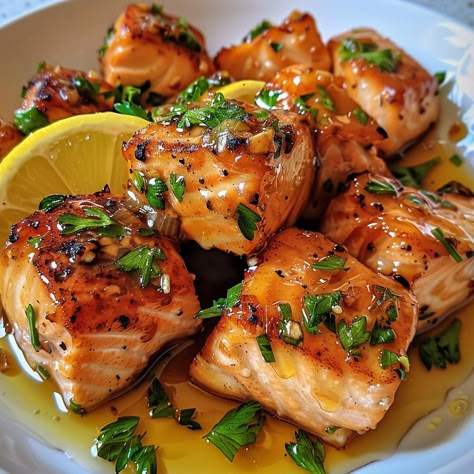 🐟✨ Luxurious Honey Butter Garlic Glazed Salmon Bites are a must-try for seafood lovers! 🐟 🐟 Honey Butter Garlic Glazed Salmon Bites 🛒 Ingredients: Salmon fillets: 1 lb, cubed Butter: 3 tbsp Garlic: 3 cloves, minced Honey: 3 tbsp Lemon juice: 2 tbsp Parsley: Chopped, for garnish 👩‍🍳 Instructions: Glaze: In a pan, melt butter with garlic, then add honey and lemon juice. Cook: Add salmon cubes, cook until glazed and cooked through. Serve: Garnish with parsley. 🌟 A delightful twist on salmon ... Lemon Butter Salmon Bites, Glazed Salmon Bites, Dinner Recipes Date Night, Salmon Cubes, Food Salmon, Salmon Bites, Luxury Food, Glazed Salmon, Healthy Food Dishes