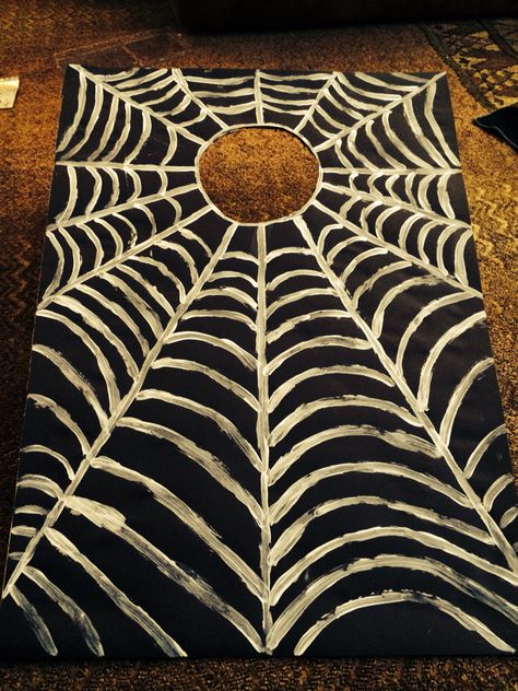 I made this corn hole spider web game for my daughter's class Halloween party. It was super easy and cheap. I used a school poster board the one that folds into 3 sections. I cut a hole in the middle and designed the spider web around the hole. I will use you spiders for the bean bags. Super cute. Halloween Cornhole Diy, Corn Hole Halloween Game, Halloween Corn Hole Boards, Halloween Cornhole Boards, Spooky Cornhole, Halloween Corn Hole, Halloween Cornhole, Spider Web Game, Harvest Board