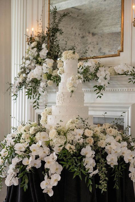 This Gorgeous cake display was at The Mason The stunning cake is designed by Dallas Affairs Bakery and of course the flowers are by us! Photo by V G Photography #wedding #weddingcake #weddingdesign #weddingdesign #weddingflowers #wildroseevents #weddingfireplace #weddingreception Cake Table Florals, Cake Table Wedding Decorations, Flower Cake Table, Floral Cake Table, Wedding Cake Tables, Wedding Cake Table Decor, Wedding Cake Display Table, Cake Table Wedding, Vintage Wedding Cake Table