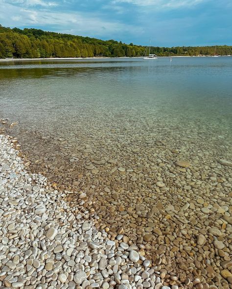 Can you believe this pebble beach is in the Midwest?! 📍Schoolhouse Beach, Washington Island, Wisconsin Located at the very northern tip of Door County, WI, this island is only accessible by ferry. Instead of sand, this beach is covered with smooth limestone pebbles. The water is so clear that you can see a shipwreck sunken at the bottom of the bay if you paddle board out over top of it. To preserve its natural beauty, there is a strictly enforced fine for removing any of the stones fro... Washington Island Wisconsin, Washington Island, Door County Wi, Door County, Paddle Board, Family Outdoor, Shipwreck, Pebble Beach, Family Adventure