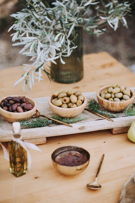 Greek wedding, Mediterranean wedding, Your Lefkada Wedding, olive bar, wedding welcome table Olive Oil Bridal Shower Theme, Olive Bar Wedding, Olive Oil Tasting Bar, Grazing Centerpiece, Olive Tree Themed Wedding, Olive Theme Party, Mediterranean Wedding Food, Cheese Styling, Olives Wedding