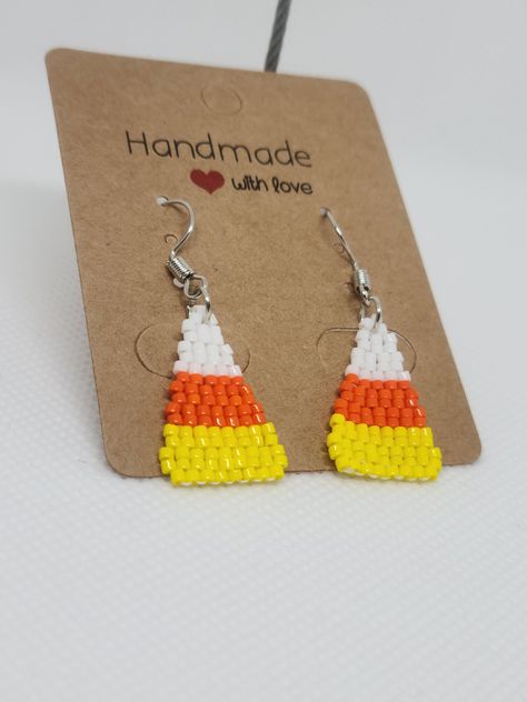 Halloween Candy Corn Beaded Earrings   ITEM DESCRIPTION: - You will receive one pair of sturdy, handcrafted colourful beaded earrings. - These earrings are made using 11/0 glass Miyuki Delica beads, traditional Indigenous beading techniques, and conditioned Nymo beading thread. - The design of these earrings is candy corn. The earrings are done in two drop brick stitch.  - These earrings are very lightweight, and perfect for everyday or formal wear. - As this item is made to order just for you, Beaded Candy Corn, Candy Corn Seed Bead Earrings, Halloween Beaded Earrings Patterns Free, Candy Corn Beaded Earrings, Beaded Earrings Halloween, Seed Bead Halloween Earrings, Seed Bead Earrings Patterns Tutorials, Beaded Halloween Jewelry, Halloween Seed Bead Earrings