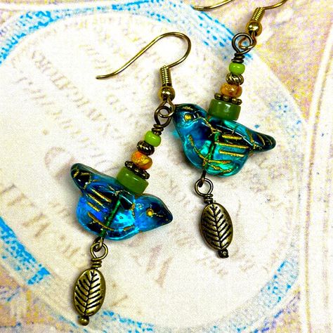 A Sage & Silver Original. These Are The Sweetest Birdie Earrings To Welcome Our Long Awaited Spring. The Bird Beads Are Peacock Blue - Teal Colored Pressed Czech Glass With Some Iridescence. They Are Accented With Jade, Brass Beads & Agate, Dangling From 18kt Gold Plated Ear Wires. Super Sweet , Cheerful & Happy. Would Make A Perfect Gift For Your Bird Loving Friend. Made By Me New, Never Worn 18kt Gold Plated Nickel Free Ear Wires Bird Earrings Blue Green Teal Peacock Gold Unique Original Handm Czech Beads Jewelry, Czech Glass Jewelry, Beaded Jewelry Earrings, Earrings Ideas, Bird Beads, Inspirational Jewelry, Earrings Colorful, Brass Beads, Earring Ideas