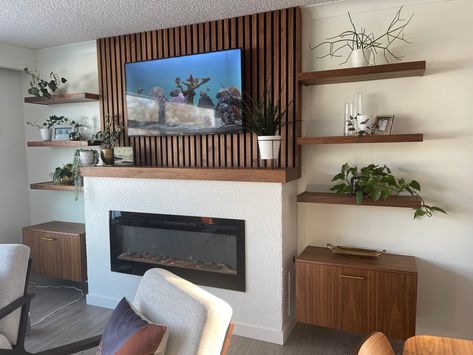 Walnut wood custom built idea for livingroom. Custom made fireplace cabinet. Wood Slats Around Fireplace, Wood Paneling Above Fireplace, Fireplace With Wood Slats, Slat Wall With Fireplace, Slat Fireplace Wall, Slat Wall Fireplace, Wood Slat Fireplace, Mid Century Modern Fireplace Ideas, Slat Fireplace