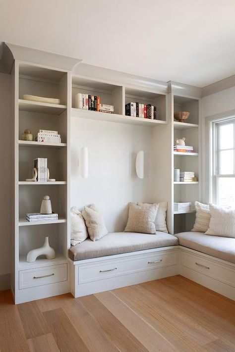 Light gray bookcases frame a light gray built-in bench topped with a gray cushion and adorned with polished nickel pulls. Bookcase In Bedroom, Bookcase Bench, Seating Nook, Built In Bench Seating, Corner Bench Seating, Built In Window Seat, Window Seat Design, Built In Shelves Living Room, Bookcase Design