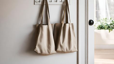 Professional organizers share their thoughts on how to store tote bags to keep your reusables easy to find and under control – so you never forget to take them to the store again. How To Store Reusable Bags, Professional Organizers, Mud Room Storage, Small Space Storage, Folding Bag, Pantry Shelf, Storage Places, Small Entryway, Nylon Tote Bags