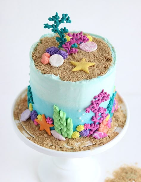 under the sea cake with seashells and coral reef 3 Teir Cakes Ideas, Birthday Sea Theme, Under The Sea Smash Cake, Easy Mermaid Cake, Axolotl Cake, Ocean Theme Cake, Ocean Birthday Cakes, Wave Cake, Under The Sea Cake