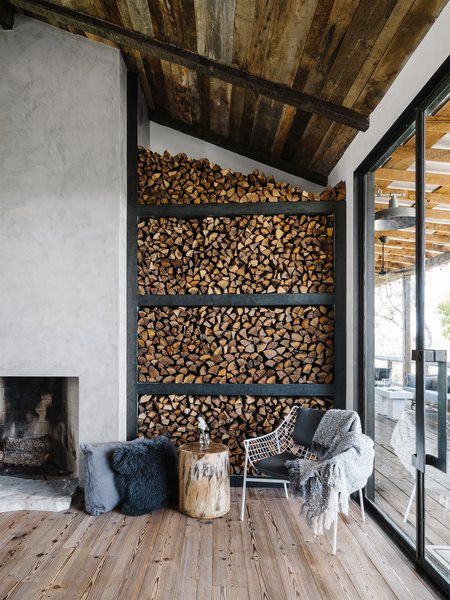 Living Room, Chair, End Tables, Wood Burning Fireplace, Medium Hardwood Floor, and Standard Layout Fireplace The existing structures were updated with a material palette that included natural aging patinas, raw steel doors and shelves, zinc countertops, and wood-paneled and beamed ceilings—juxtaposed with clean plaster finishes. Ranch House Remodel, Ranch Remodel, Steel Shelving, Firewood Storage, Cabin Kitchens, Downtown Austin, Ranch Style Homes, Design Del Prodotto, Updating House