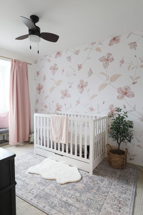 This Baby girl nursery is an absolute dream. Its soft, airy with a touch of punctuation through the black dressert and the floral wallpaper is a stunning foca point! #nursery #nurserydecor #nurseryideas #babygirlnursery #girlbedroomideas #nurseryinspiration #babynurserydecor #lilyjunehome Nursery Baby Girl Wallpaper, Floral Nursery Inspiration, Nursery With Floral Wallpaper, Wallpaper For Nursery Girl, Baby Girl Wallpaper Nursery, Baby Girl Nursery With Wallpaper, Girls Nursery Wallpaper, Baby Girl Room Wallpaper, Nursery Accent Wall Girl