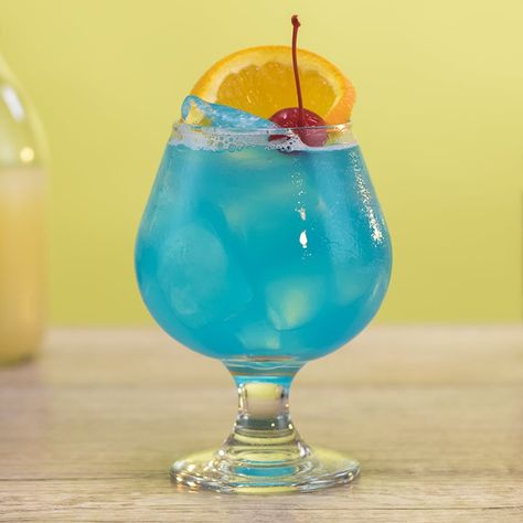 BLUE OCEAN 1 oz (30ml) Vodka 1/2 oz. (15ml) Blue Curaçao 1/2 oz.(15ml) Simple Syrup  2 oz. (60m) Grapefruit Juice Garnish: Orange Slice, Cherry  PREPARATION 1. In a shaking glass with ice, combine vodka, blue curaçao, simple syrup, and grapefruit juice. Shake well.  2. Strain mix into a Brandy snifter over ice and garnish with an orange slice and a cherry.  DRINK RESPONSIBLY! Ocean Drink, Ocean Cocktail, Blueberry Martini, Vodka Mixers, Vodka Blue, Cherry Drink, Brandy Snifter, Kiwi Berries, Raspberry Vodka