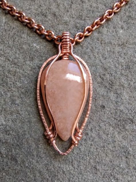 This is a Handmade Wire Wrapped Copper Beautiful Peach Moonstone Pendant   it has a Very Nice Flash in the Sun Gift Box or Velvet Bag Available for $1.00 Actual Shipping Costs Me $5 at the Minimum for 1 Single Item and I Pay the Difference. $4.75 Shipping to all 50 U.S. States With Tracking. -Please Read before Ordering- The kinds of metals (Sterling Silver, Copper, Brass) used in the jewelry I make are left natural (unsealed) and will develop a natural patina overtime. Metal oxidizes over time when it comes in contact with oxygen in the environment and skin. For many people the acids in your skin combine with the metal and make copper or silver salts which are greenish or gray. They are harmless and just wash off. Small Wire Wrapped Pendant, Wire Wrapped Pendant Tutorial, Rose Gold Copper Wire Wrapped Necklaces, Elegant Copper Wire Wrapped Necklace, Rose Gold Wire Wrapped Pendant Crystal Necklace, Wire Wrapped Sun Pendant, Nature-inspired Copper Wire Pendant Jewelry, Copper Wire Gemstone Pendant Necklace, Copper Jewellery