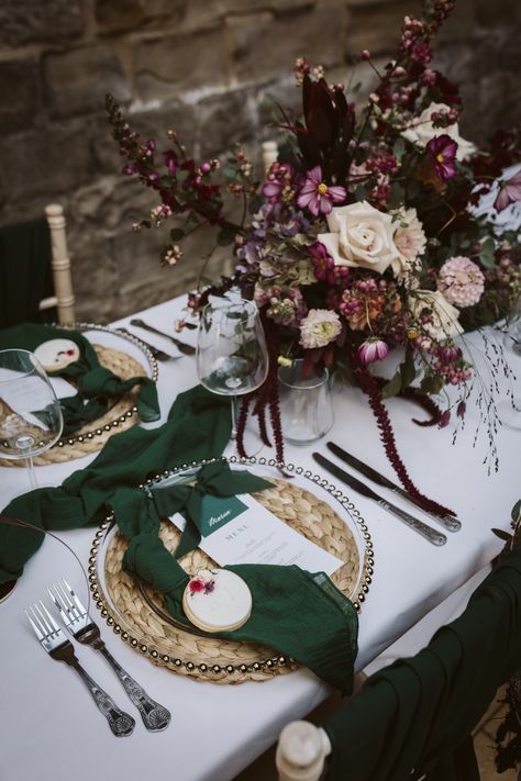 Dark red, pink and white wedding bouquets on white tablecloth with wicker place mat, dark green napkin and wedding place name with biscuit wedding favours | wedding table decoration | wedding autumnal and winter theme | wedding favours | Hannah Brooke Photography Red Tablecloth Wedding, Green Burgundy Wedding, Winter Theme Wedding, Green And Burgundy Wedding, Biscuit Wedding Favours, Pink And White Wedding, Autumnal Wedding, Favours Wedding, Pink And White Weddings