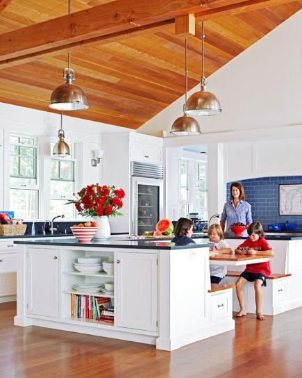 Black honed granite countertops and industrial pendants look sleek in this spacious white Michigan kitchen. Kitchen Island Booth, Nooks Ideas, Kitchen Booths, Kitchen Layouts With Island, Kitchen Island Bench, Kitchen Blue, Breakfast Nooks, Booth Seating, Kitchen Island With Seating