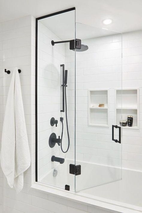 A matte white subway tile is added to this bathroom, pairing perfectly with the matte black faucets and hardware / Source #bathroomtiles White Subway Tile Bathroom, Black Fixtures, Subway Tiles Bathroom, Bathroom Tub Shower, Glass Shower Door, White Bathroom Designs, White Subway Tiles, Bad Inspiration, White Subway Tile