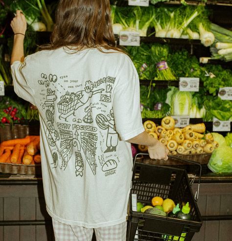 #SupermarketTee The perfect top for a casual look. Lightweight and breathable, this tee is made from a soft cotton blend. With its relaxed fit and classic crew neck, it's perfect for layering or wearing on its own. #casual #tee #summer . #Brownie_Points #Brand_Board #Indie_Design #Tee_Design Grocery Store Branding, Supermarket Branding, Cafe Merch, Hard Crafts, Illustration Tshirt, Fun Tshirt, T-shirt Photography, Merch Design, Brownie Points