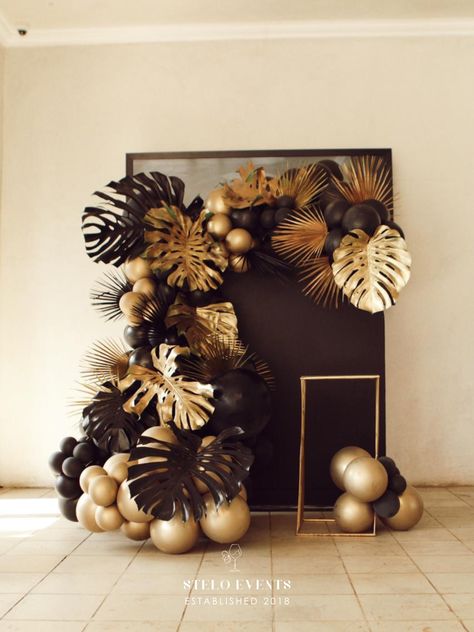 Black And Gold Tropical Party, Classy Tropical Theme Party, Black And Gold Party Backdrops, Green Gold And Brown Party Decor, Black Gold Event Decor, Birthday Decor Classy, Black And Brown Party Theme, Elegant Tropical Party Ideas, Sophisticated Party Decor