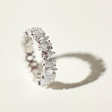 A breathtaking reinterpretation of the eternity band, diamond-shaped pears are hand placed at precise angles to symbolize perfect complementarity. Recycled 18k gold hold in place D color, IF/VVS clarity pear-shaped diamonds. Size and color are fully customizable. Available in two carat weights: 2.5 and 5 (based on a U.S. size 7). Total carat weight varies based on ring size. Eternity Rings Diamond, Pear Eternity Ring, Unique Eternity Ring, Diamond Ring Bands, Pear Wedding Band, Ring Enhancers, Wedding Bands Diamond, Eternity Diamond Ring, Trilogy Engagement Ring