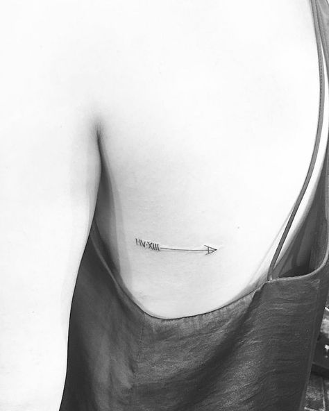 rib-cage-arrow-roman-numeral-wrist-tattoo-black-top-white-black-photo Arrow Rib Tattoo, Jonboy Tattoo, Tattoo Arrow, Small Rib Tattoos, Roman Numeral Tattoos, Date Tattoos, Intricate Tattoo, Arrow Tattoo, Arrow Tattoos