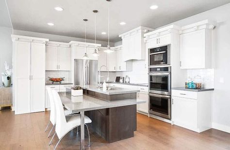 Modern kitchen with two tier island with seating gray quartz countertops Two Tiered Kitchen Island, Tiered Kitchen Island, Two Tier Island, Floating Kitchen Island, Kitchen Cabinet Trends, Gray Quartz, White Shaker Kitchen, Above Kitchen Cabinets, Shaker Kitchen Cabinets