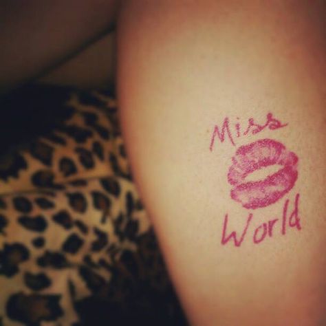 Miss World kiss-print tattoo Emo 2000s Tattoo, Mcbling Tramp Stamp, Tiger Tramp Stamp, Mcbling Tattoo Ideas, Miss World Hole, Juicy Couture Tattoo, Courtney Love Tattoo, Hole Tattoo Band, Mcbling Tattoo