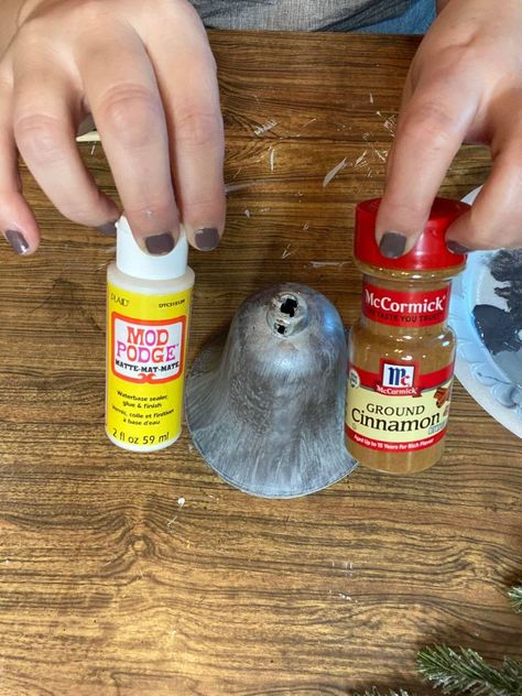 Using mod podge and cinnamon to create faux rust on the painted plastic bell How To Paint Rust Effect, Cinnamon Rust Technique, Using Cinnamon As Rust, Faux Rust With Cinnamon, Faux Rust Paint Diy, Mod Podge Christmas Ornaments, Cinnamon Pumpkins, Primitive Recipes, Rust Painting