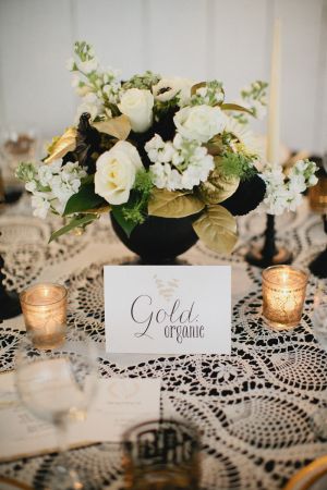 White and Gold Flowers in Black Vase | photography by http://www.kristynhogan.com/ | Venue, Floral, Event Styling, Decor, and Custom Signage by http://www.cedarwoodweddings.com/ Black White Gold Silver Wedding Centerpieces, Gold Painted Flowers, Black White Gold Floral Arrangement, Black And Gold 50th Anniversary Centerpieces, Black White Gold Flower Arrangements, Black White And Gold Floral Arrangements, Black White Silver Flower Arrangements, Black And Gold Centre Piece, Gold And Black Table Centerpieces