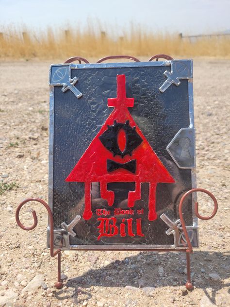 This is a stained glass sculpture of The Book of Bill. The cover is made using ethically sourced snake skin shed preserved between 2 pieces of glass. The Book Of Bill, Book Of Bill, Stained Glass Sculpture, Props Concept, Fall O, Well Well, Bill Cipher, Glass Color, Glass Texture