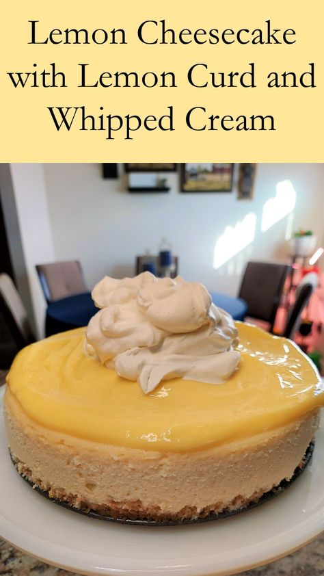 Image depicts a whole cheesecake topped with lemon curd and whipped cream sitting on a cake stand. Lemon Cheesecake With Lemon Curd, Lemon Custard Cheesecake, Cheesecake Lemon Curd, Lemon Curd Cheesecake Recipe, Cheesecake With Lemon Curd, Strawberry Lemon Cheesecake, Lemon Dishes, Flavored Cheesecake, Fun Cheesecake Recipes