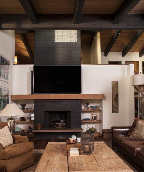 Mid-Century Modern Brick Fireplace Painted Black. Light wood mantle and built-in shelving. Light wood vaulted ceiling with exposed beams stained black. Light Wood Mantle, Fireplace Painted Black, Brick Fireplace Painted, Fireplace Painted, Black Brick Fireplace, Mid Century Modern Fireplace, Wood Mantle Fireplace, Tv Wall Decor Ideas, Vaulted Ceiling Living Room