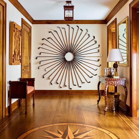 A collection of antique golf clubs becomes the perfect piece of art for this basement hallway. Photo by @ericpiasecki #design #interiordesign #interiors #art #golf #golfclubs #antiques #classic #classicdesign #wood Golf Club Wall Display, Golf Club Art, Basement Hallway, Golf Bar, Golf Crafts, Golf Pro Shop, Golf Simulator Room, Golf Clubhouse, Golf Room