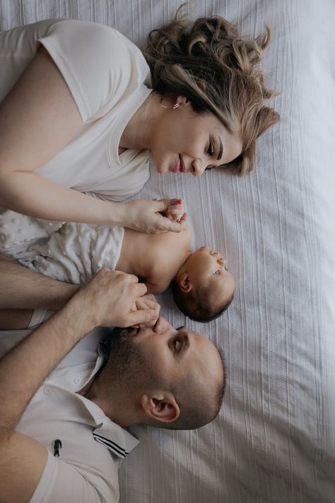 New parents lying on a bed, the mother and father each touching their newborn's hands, sharing a serene and loving moment with their baby. Photoshoot In Dubai, Newborn Photoshoot Ideas, Photo Album Gift, Newborn Birth, Birth Photography, New Family, Newborn Photoshoot, Family Photoshoot, Portrait Photo