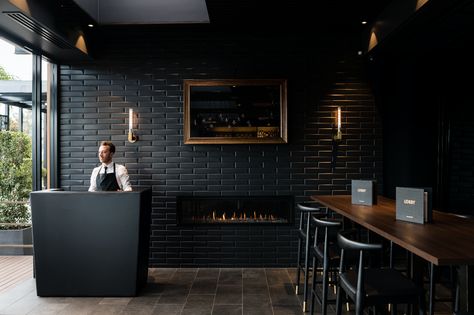 Black subway tile feature wall at 'The Lobby', Le Montage, Sydney.     Interior design by Lorena Gaxiola Black Restaurant Interior Design, Black Restaurant Interior, Black Walls Restaurant, Black Bar Interior Design, All Black Coffee Shop, Black Coffee Shop Design, Black Cafe Aesthetic, Black Interior Restaurant, Black Cafe Interior