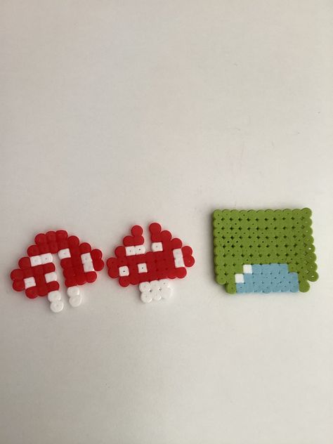 This is a 3d mushroom with a grass and a pond, you can copy by looking and the beads. Perler Bead Art Mushroom, Small Mushroom Perler Bead Patterns, Fuse Beads Mushroom, Perler Beads Mushroom 3d, Trippy Mushroom Perler Bead Patterns, Mushroom 3d, Melt Beads Patterns, 3d Pattern, Diy Perler Beads