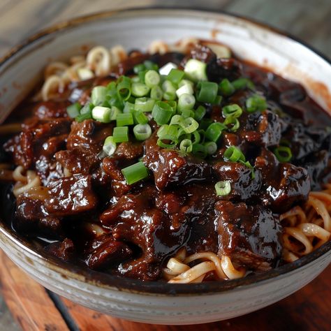 🍜 Slurp up some Jjajangmyeon! Dive into the heart of Korean cuisine. #NoodleHeaven Korean Black Noodle - Jjajangmyeon Ingredients: Jjajangmyeon noodles (1 pack) Pork belly, diced (1/2 lb) Black bean paste (1/4 cup) Onion, diced (1) Cucumber, julienned (to garnish) Vegetable oil (2 tbsp) Sugar (1 tsp) Water (1 cup) Instructions: Cook noodles according to package directions. Heat oil, sauté pork belly and onions until golden. Stir in black bean paste, water, and sugar. Simmer until thickene... Black Noodles, Black Bean Paste, Black Bean Noodles, Instagram Recipes, Trending Recipes, Bean Paste, Pork Belly, Black Bean, Black Beans