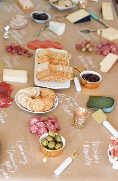 cheese board on kraft paper Kraft Paper Food Table, Butcher Paper Party Decor, Craft Paper Buffet Table, Wine And Cheese Party Decor, Charcuterie Board Ideas On Brown Paper, Craft Paper Charcuterie Table, Charcuterie Board Ideas Butcher Paper, Butcher Paper Tablecloth Party, Kraft Paper Table Setting