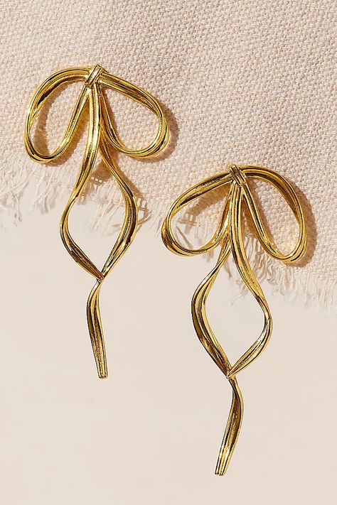 By Nubyen Pirouette Bow Earrings | Free People Gold Formal Accessories, Black Tie Earrings, Gold Earrings Formal, Elegant Formal Earrings, Gold Vintage Earrings, Bow Earrings Gold, Gold Bow Earrings, 70s Jewelry Disco, Dangly Gold Earrings