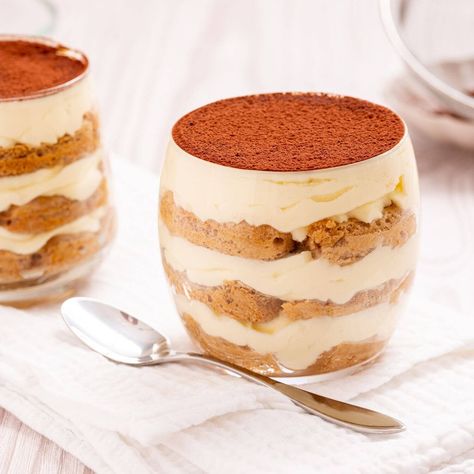 Two glass cups of layered tiramisu with a dusting of cocoa powder on top, placed on a white napkin beside a silver spoon. Tiramisu Cups, Lady Finger Cookies, Mini Pavlova, Espresso Powder, Mascarpone Cheese, Easy No Bake Desserts, Nutrition Labels, Vanilla Wafers, Chocolate Sauce