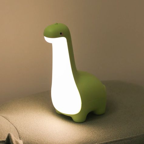 Description Shipping Looking to add a mighty glow to your room? This long dinosaur night light will help you fall asleep in seconds if you're scared of the dark. Its sleepy cute design and pastel-themed appearance are perfect for adults or children alike to help them relax before drifting off to sleep. Featuring a cute and sleek dinosaur design available in 3 colours.Measurements: 175*124*78mmCharging interval: 2.5 hoursDuration: up to 120 hours A gentle warm glow to light up your desk With a convenient size and easy-to-use, it's the perfect night light for those early mornings or late nights. Tap the back of the light to turn the light on and adjust the brightness of the light. Also makes a great gift! Features ✨ High-quality Silicone & ABS material✨ Warm soft light to keep your room feel Aesthetic Room Decor Products, Dino Night Light, Animal Product Design, Calm Decorating Ideas, Glow In The Dark Room Decor, Cool Room Decor Items, Cool Car Decor, Stuff You Need, Things To Get For Your Room