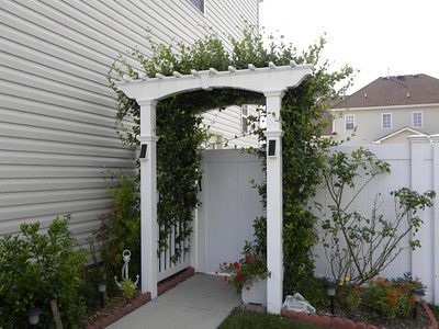 Fence Gate Trellis, Front Arbor Entrance, Vinyl Arbor With Gate, Fence Gate With Pergola, Gate With Arbor Entrance, Arbor Gate Entrance, Arbor Over Gate, Flagstone Backyard, Entry Arbor