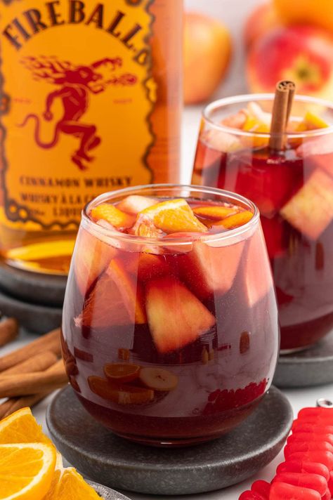 Fireball Sangria garnished with fruit slices. Carmel Apple Sangria Recipes With Fireball, Sangria Punch Bowl, Caramel Apple Sangria With Fireball, Fireball Caramel Apple Sangria, Fireball Apple Cider Sangria, Fireball Sangria Recipe, Apple Pie Sangria Recipe, Fireball Balls, Sangria Garnish