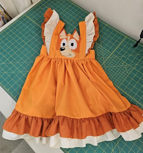 Chelsea is such a special Auntie, this is the second beautifully made appliqued dress she has made for her niece. First she made Bluey and now Bingo. Dress pattern adapted to frame their faces. All the swirling power and frills that any little girl could ever wish for! #sewingclasses #sewingday #sewingforkids #bestauntie #blueyandbingo Bluey Dress For Girl, Bluey Dress, Beautifully Made, Sewing For Kids, Dress Pattern, Bingo, No Frills, And Now, Chelsea