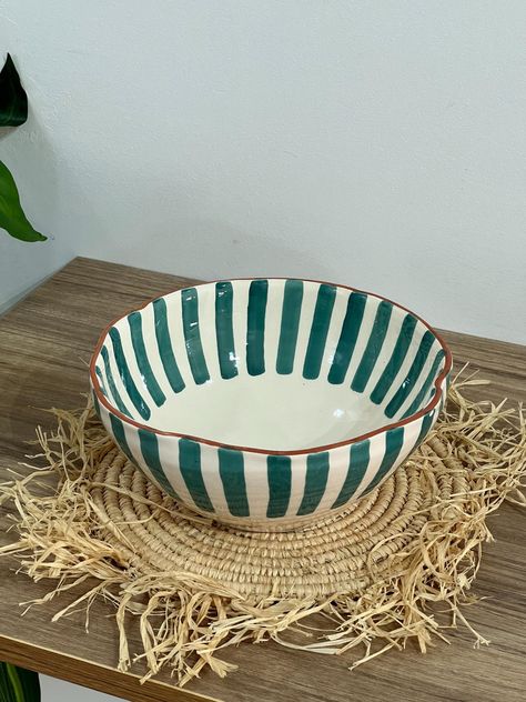 ✨ Infuse your table with the elegance of Moroccan artistry with this exquisite handmade ceramic salad bowl. Perfect for serving salads, fruits, or any favorite dish, this bowl blends traditional craftsmanship with modern design, making it a standout addition to your kitchen. 𝗙𝗲𝗮𝘁𝘂𝗿𝗲𝘀: ✤ Artisanal Craftsmanship: Handcrafted by skilled Moroccan artisans, each bowl is a unique masterpiece, showcasing the rich tradition of Moroccan pottery. ✤ Distinctive Design: Featuring wavy sides and vert