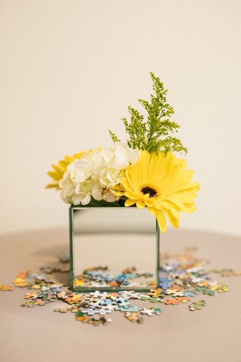 Mirrored Box Centerpiece with Puzzle Pieces Photography By: Jordan Brian Photography #MirroredBox #Flowers #PuzzlePiece #EventDesign #EventDecor #CorporateEvent #Centerpiece #Yellow #Multicolor #Greens #DFWEventDesign Brain Centerpieces, Puzzle Piece Centerpieces, Puzzle Piece Centerpiece Ideas, Puzzle Theme Party, Conference Centerpieces, Byron Wedding, Conference Decor, Round Table Centerpieces, Puzzle Ideas