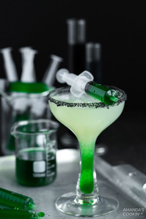 Green goo meets this refreshing Frankenstein margarita loaded with tequila and lime juice in a black lava salt rimmed glass. Spooky Tequila Cocktails, Frankenstein Margarita, Frankenstein Drink, Halloween Tequila Cocktails, Halloween Margarita Recipe, Spooky Margaritas, Halloween Margaritas, Drinks With Alcohol, Halloween Beverages