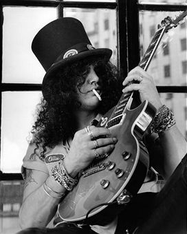 Photo of GUNS AND ROSES and GUNS & ROSES and GUNS N' ROSES and SLASH; Slash, posed, studio, smoking cigarette, holding Gibson Les Paul guitar Saul Hudson, Duff Mckagan, Les Paul Custom, Musica Rock, Dave Matthews Band, Axl Rose, I'm With The Band, Dave Matthews, Stanley Kubrick