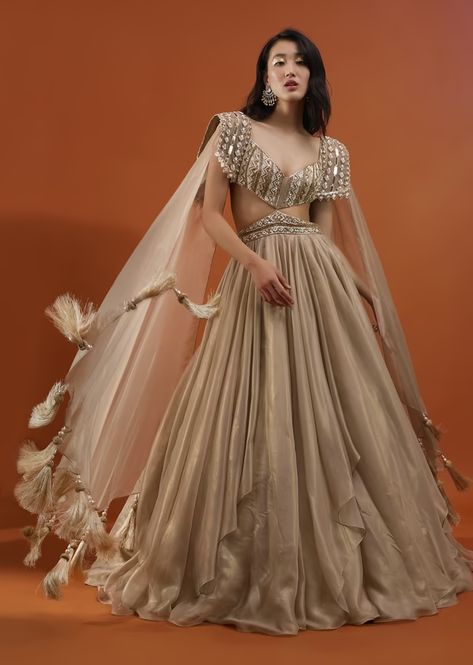 Champagne Gold Akasia Gown With Tassel Wing Cape Sleeves - NOOR 2022 Cape Dress Indian, Indian Reception Outfit, Sangeet Dresses, Wing Cape, Engagement Dress For Bride, Gold Organza, Reception Outfits, Organza Gown, Dresses For Bride