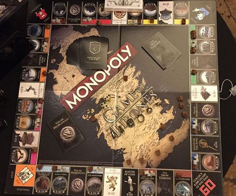 Help pass the time between TV seasons by playing on this Game Of Thrones edition Monopoly game board. All aspects of the game including tokens, cards and even play money have been customized for fans of the iconic franchise. Monopoly Game Board, Santa Games, Game Of Thrones Merchandise, Monopoly Game, Hbo Game Of Thrones, Play Money, Classic Board Games, Game Board, Game Pieces