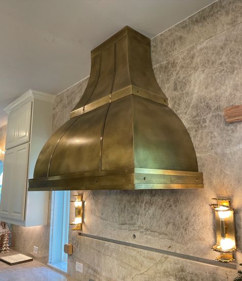 Our clients truly made this hood unique and special. We absolutely adore this stunning antique brass hood! The Royal design complements their kitchen beautifully and takes the kitchen’s focal point to a whole new level. It’s a perfect example of how a custom range hood can enhance your kitchen. There’s nothing quite like it! #rangehoods #customrangehood #customdesign #interiordesign #kitchensofinstagram #luxury Brass Vent Hood, Brass Hood, Hood Kitchen, Kitchen S, Custom Range Hood, Vent Hood, Royal Design, Range Hoods, Kitchen Decor Items