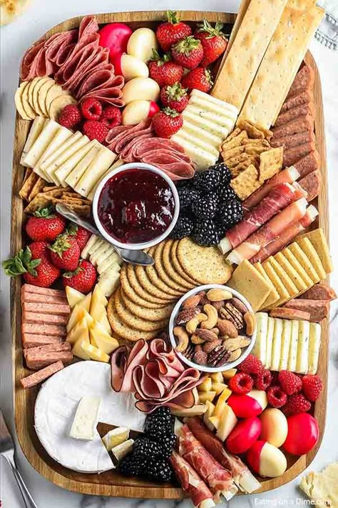 Learn how to make an easy Charcuterie board for your next party and totally impress your guests. You will be pleasantly surprised how simple it is to make. We have simple ideas to build a DIY charcuterie board everyone will love even the kids. These ideas are perfect for brunch, Christmas, 4th of July and more. #eatingonadime #howtomakeaCharcuterieboard Easy Charcuterie Board, Easy Charcuterie, Make A Charcuterie Board, A Charcuterie Board, Cheese Crackers, Charcuterie Board, Crackers, Cheese, Fruit