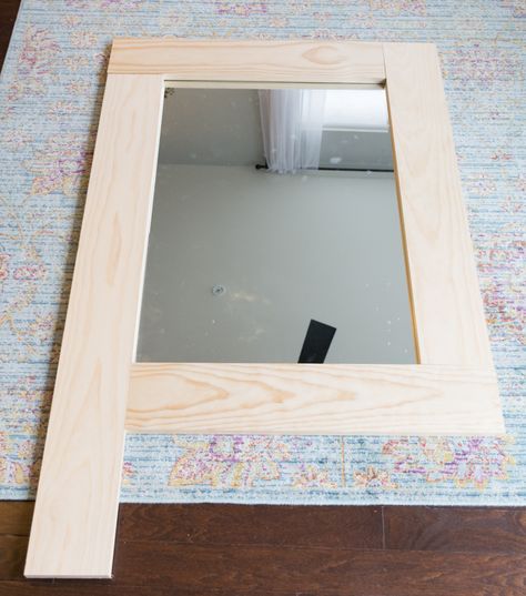 Wondering how to make a mirror frame with wood? I've got you covered! Learn how to make a simple DIY wood mirror frame for a bare mirror.